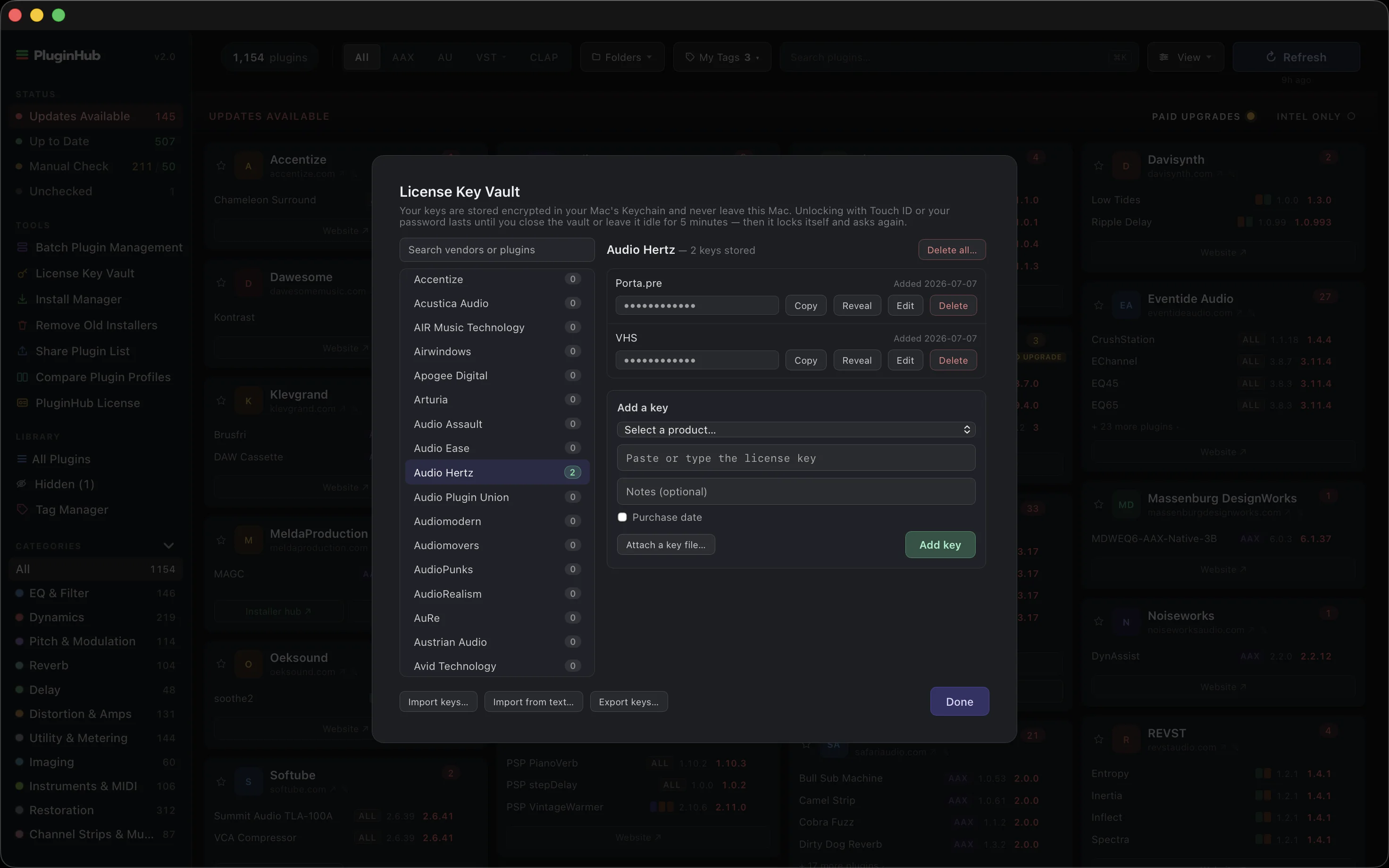 License Key Vault open over the PluginHub 2.0 dashboard, keys masked with Copy and Reveal beside each